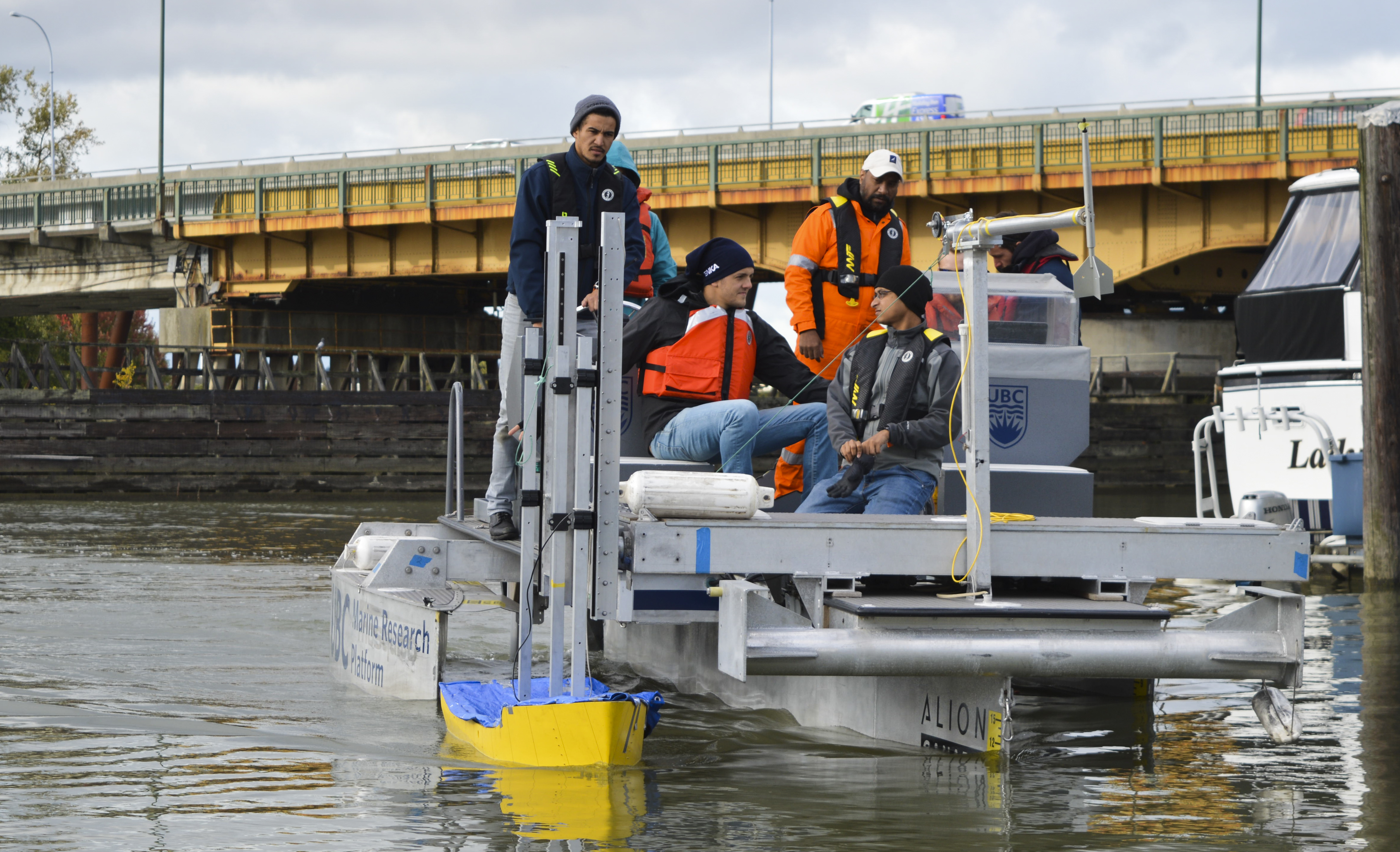 Students testing their model hull design aboard the new UBC Marine Research Platform.