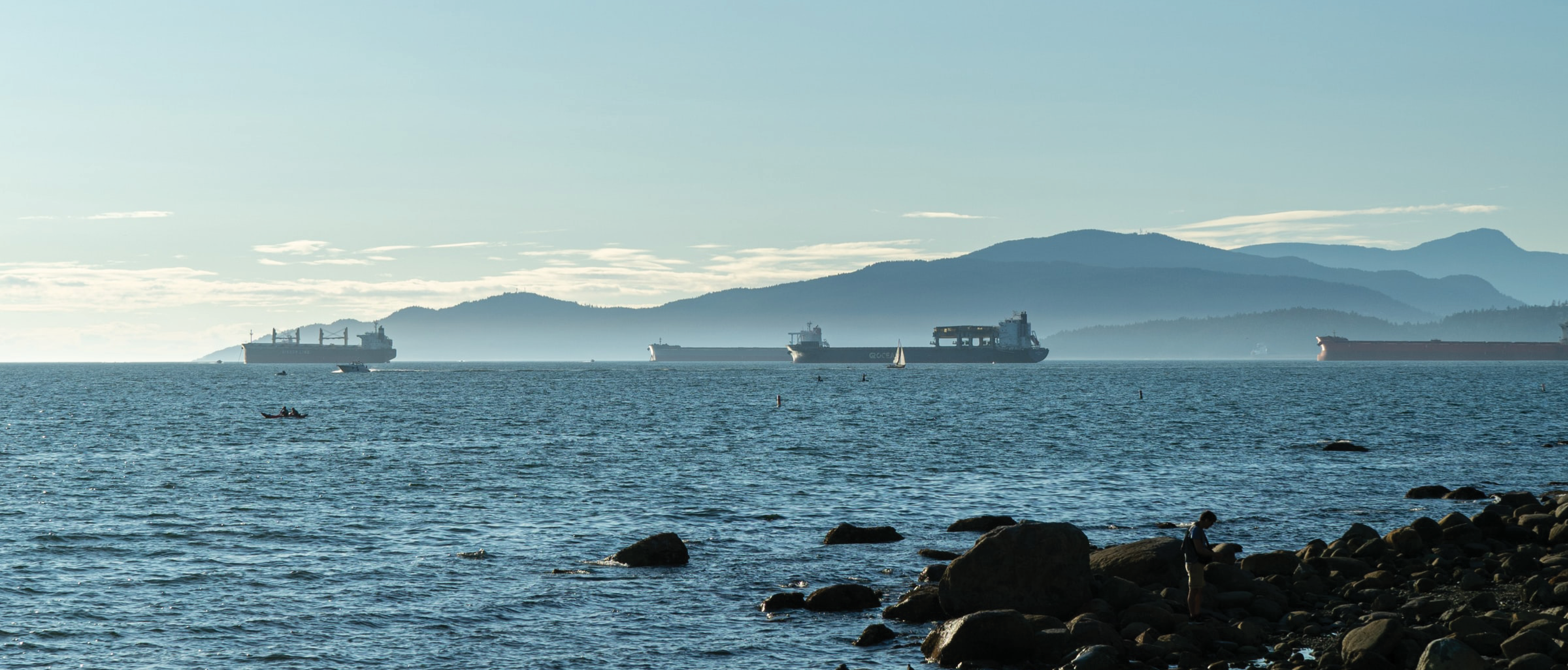 Container ships in English Bay, looking north from Spanish Banks to the mountains in West Vancouver.